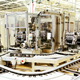 How does hierarchical control raise factory OEE from 64% to 82%?
